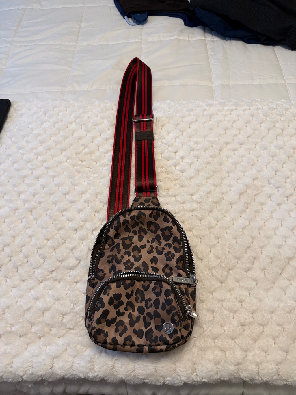 Leopard Print Sling Backpack With Red-Striped Strap